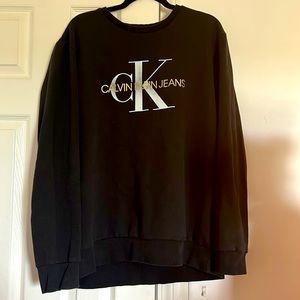 Calvin Klein sweater black with white and gold writing on front of sweater
